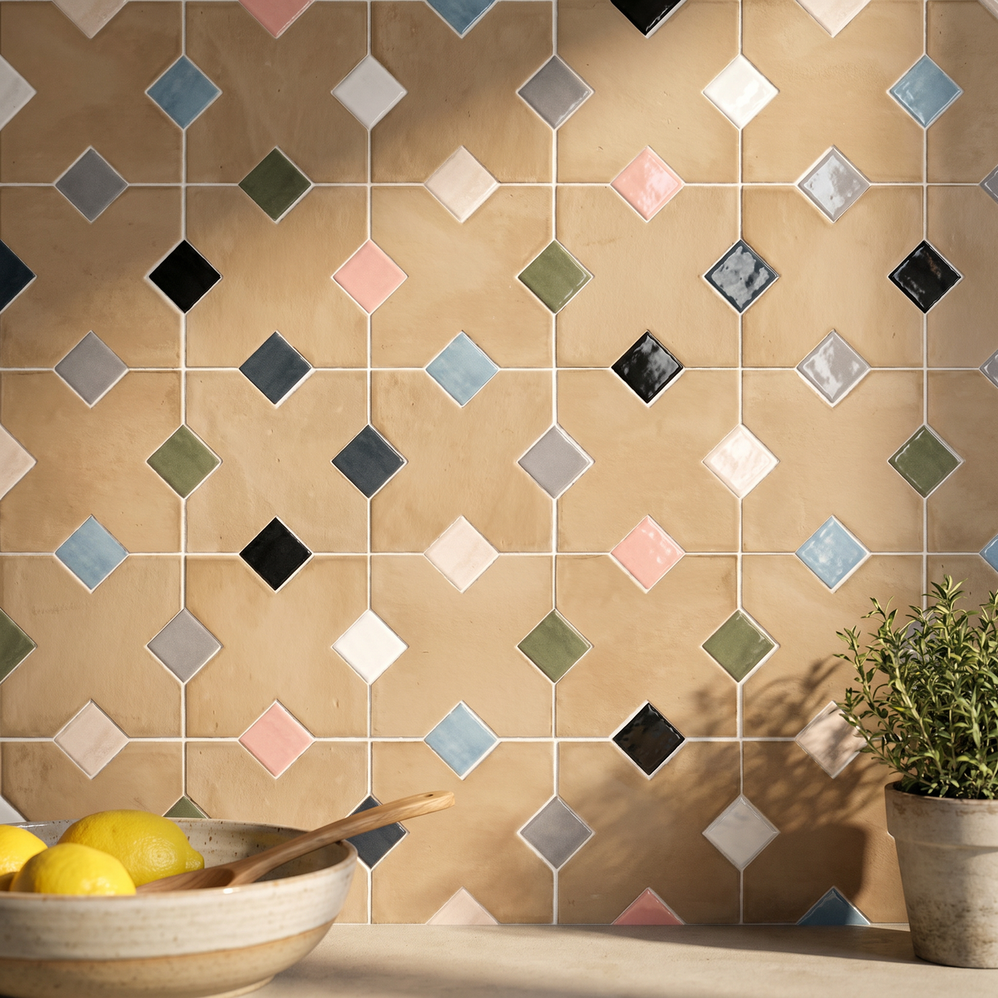 Colorful geometric tile pattern on a wall with a bowl of lemons and a plant in the foreground.