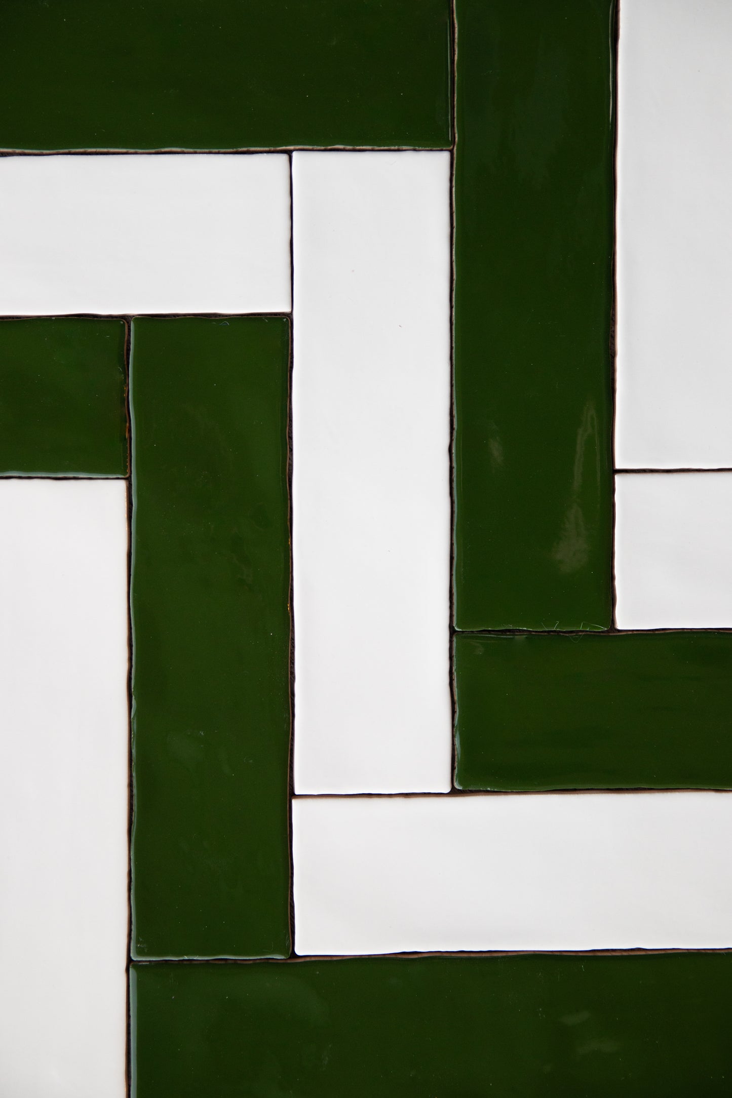 Green and White tiles in vertical herringbone pattern, slight gloss and subltle surface variation.